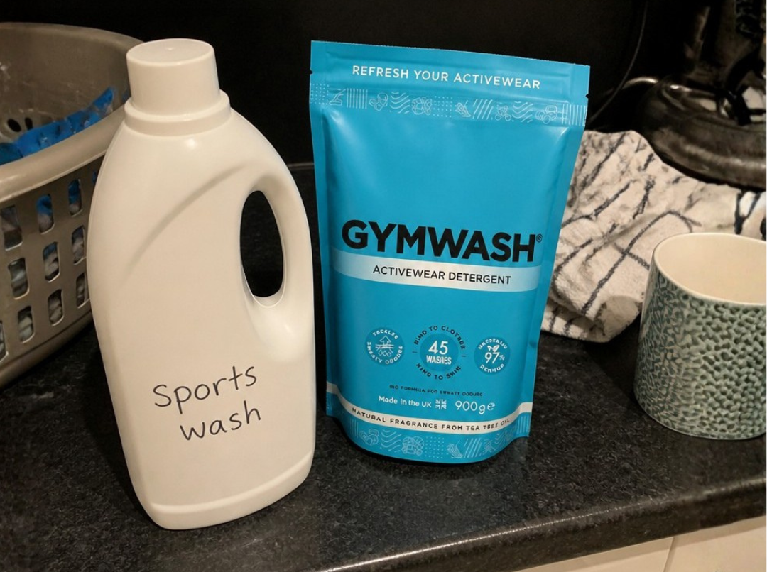 a pouch of gymwash next to a liquid detergent bottle labelled "sports wash"